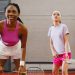 Two women playing badminton indoors, focusing on a competitive moment.